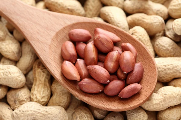 Peanuts in a wooden spoon — Stock Photo, Image