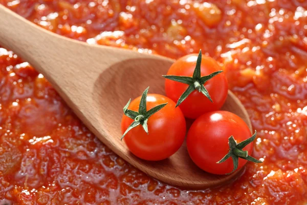 Tomato in a wooden spoon — Stock Photo, Image