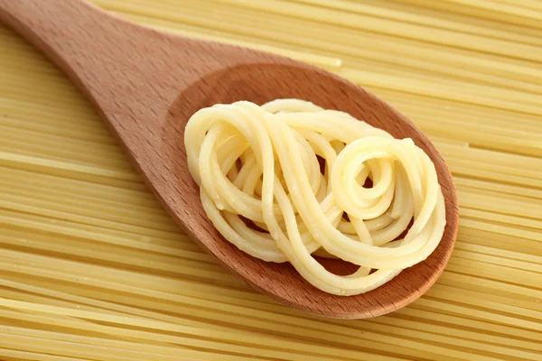 Spaghetti in a wooden spoon — Stock Photo, Image