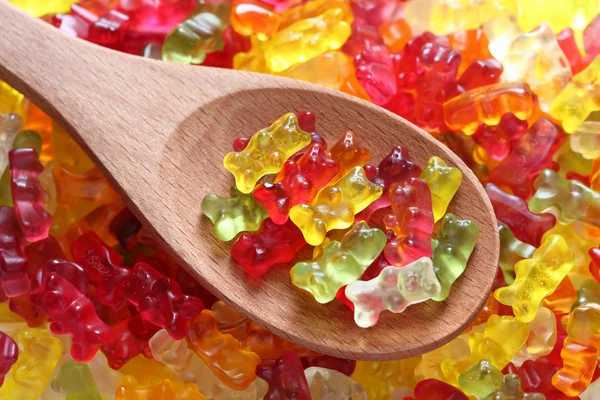 Gummy bears on a wooden spoon — Stock Photo, Image