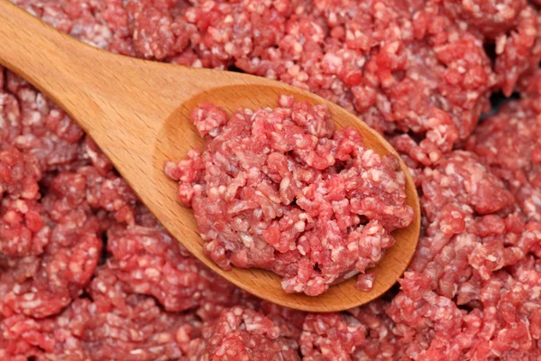 Minced meat in a wooden spoon — Stock Photo, Image