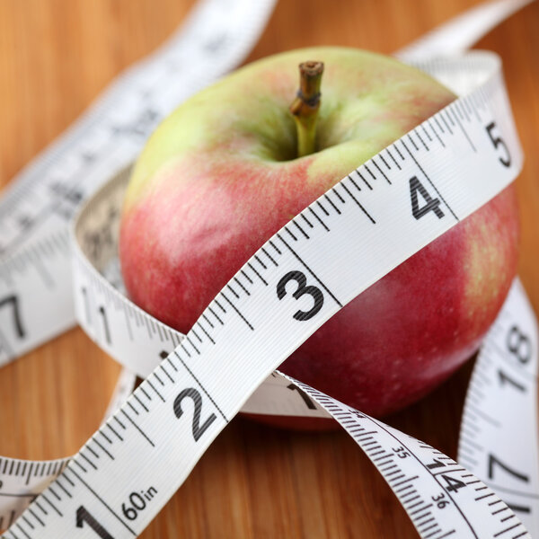 Apple wrapped in a tape measure