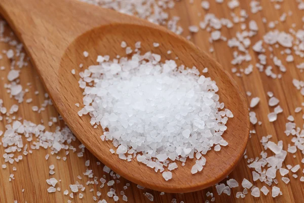 Sea salt in a wooden spoon — Stock Photo, Image