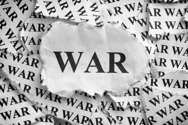 Torn pieces of paper with the word WAR — Stock Photo, Image