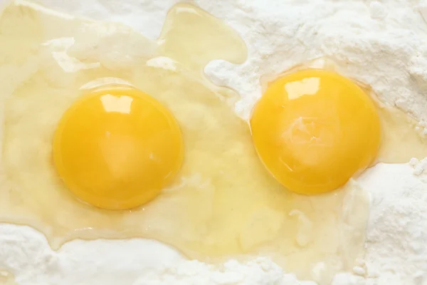 Two egg yolks and flour — Stock Photo, Image