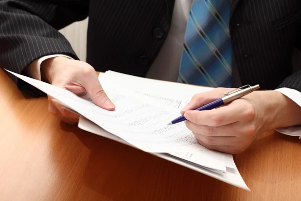 Businessman viewing financial statements — Stock Photo, Image