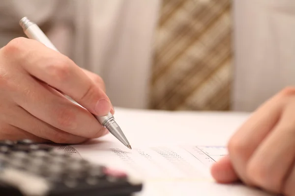 Businessman viewing financial statements — Stock Photo, Image