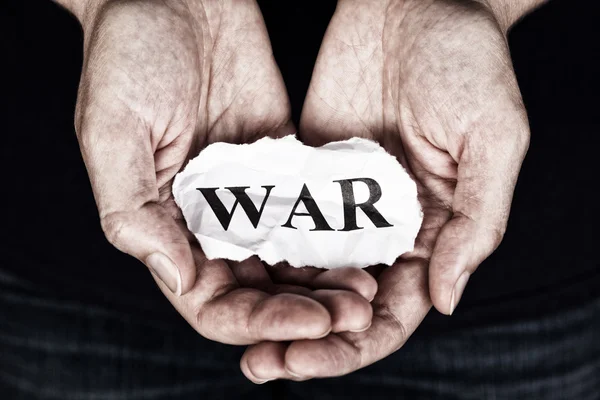 Torn piece of paper with the word War — Stock Photo, Image