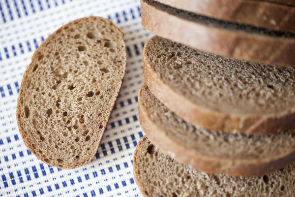 Cut loaf of brown bread — Stock Photo, Image