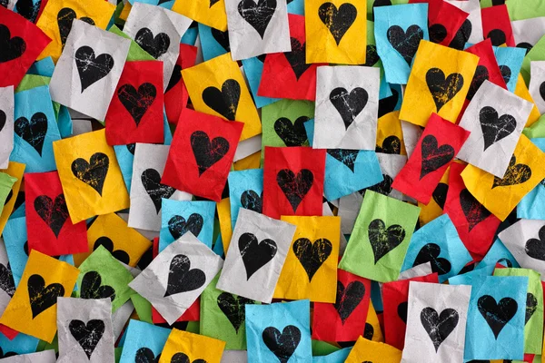 Crumpled colorful pieces of paper with hearts — Stock Photo, Image