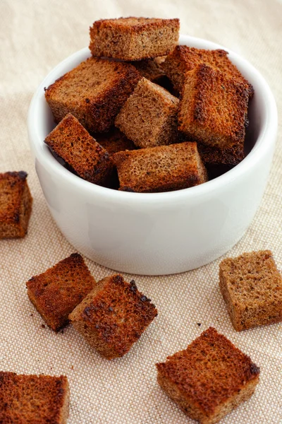 Rye homemade croutons in a white bowl — Stock Photo, Image