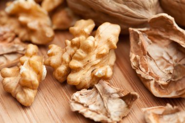 Walnuts on wooden background clipart