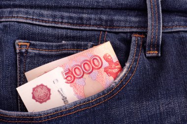 Five thousand rubles banknote in a pocket of blue jeans clipart