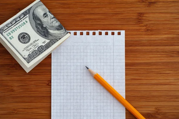 Blank sheet of paper and pencil with one hundred dollars bill on — Stock Photo, Image