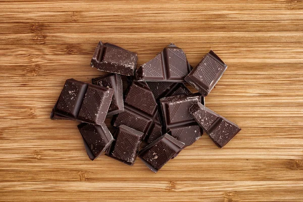 Heap of broken dark chocolate — Stock Photo, Image