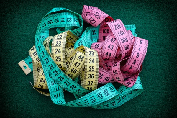 Colorful measuring tapes pile — Stock Photo, Image