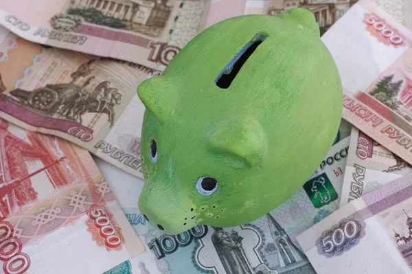 Green piggy bank and russian rubles — Stockfoto