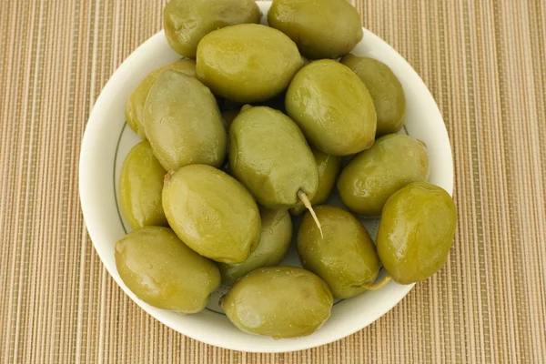 Green olives in a small plate — Stock Photo, Image