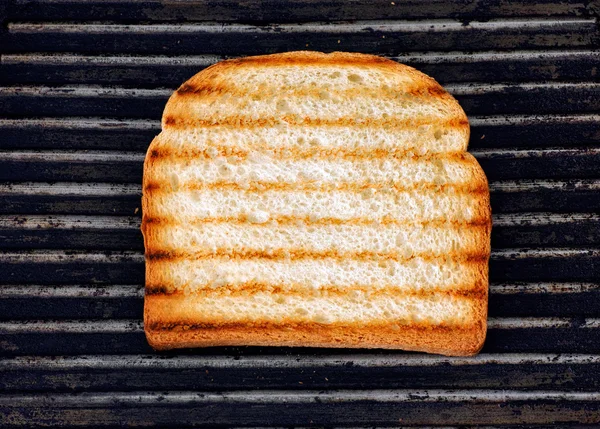 Slice of toasted bread on a grill — Stock Photo, Image
