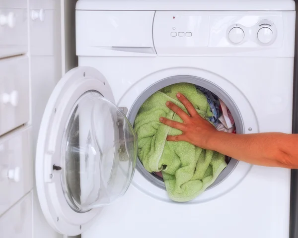 Woman loaded clothes into washing machine — Stock Photo, Image