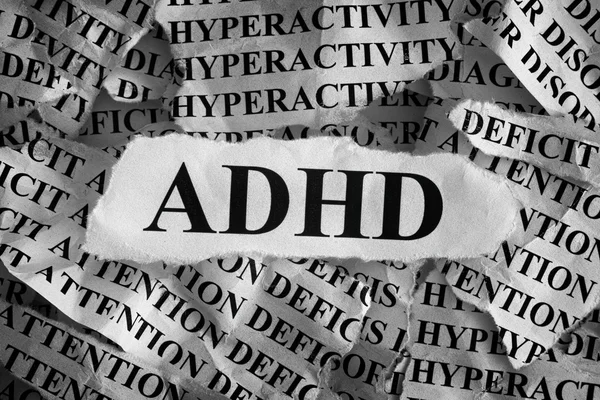 Torn pieces of paper with abbreviation ADHD — Stock Photo, Image