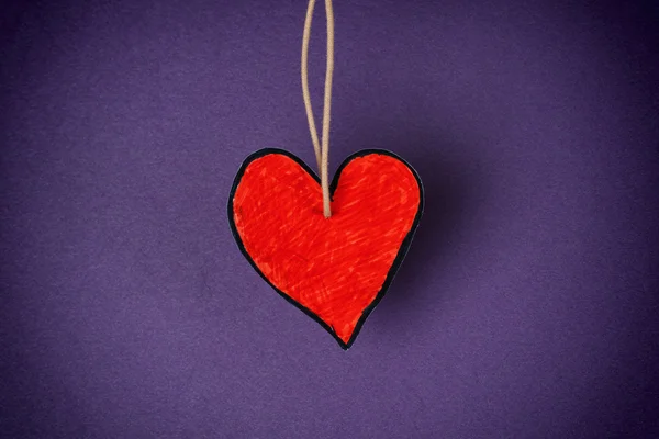 Forma del cuore di carta rossa contro sfondo viola — Foto Stock