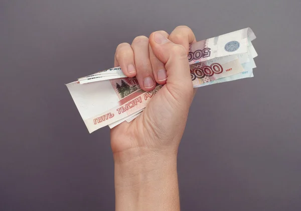 Woman hand squeezes russian money — Stock Photo, Image