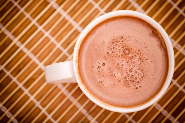 Чашка какао с молоком на бамбуковой салфетке — стоковое фото