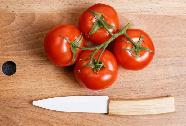 Fresh tomato and ceramic knife