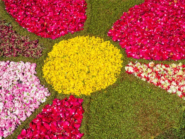 colorful design made on the ground with flowers, moss and petals, on the occasion of an Italian religious festival