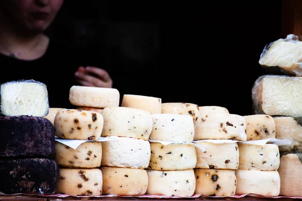 Italian healthy artisan cheeses displayed at a street shop during the mountain festival, with tasting