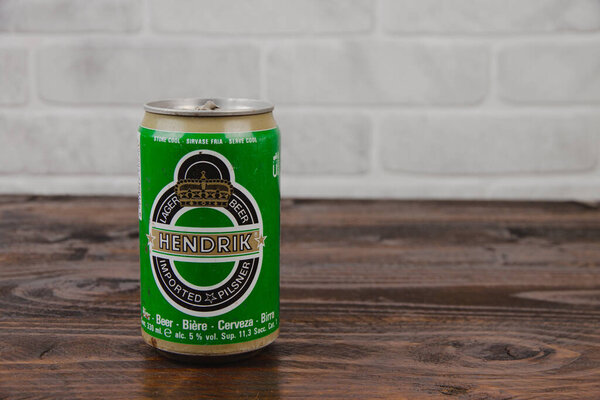 An old aluminium can of Hendrik beer against the brick wall