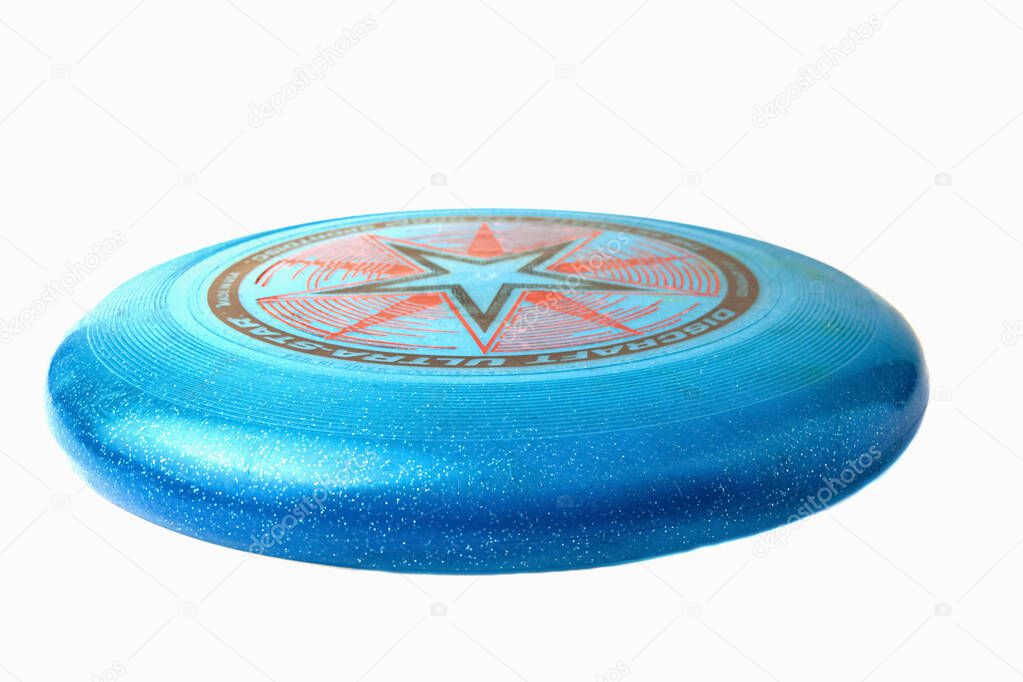 Krasnodar, Russia-December 7, 2020: Blue flying disc from Discraft. Frisbees isolated on a white background. Side view