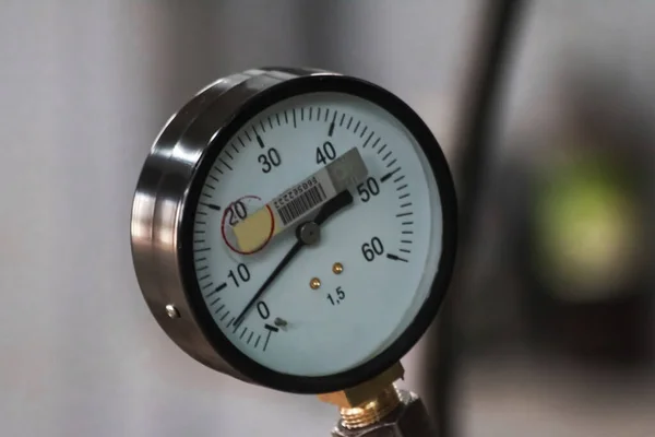 Industrial pressure gauge with dial from 0 to 60 close-up. Industrial production