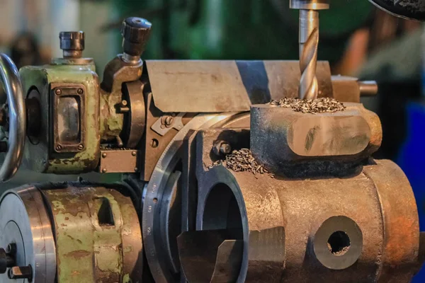 Drilling a hole in the housing of an industrial water pump. Small-scale production in Russia