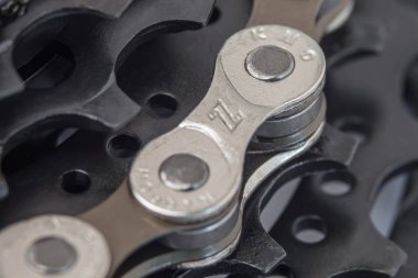 Krasnodar, Rusya - 12 Şubat 2021: Bir bisiklet kasetinin siyah dişleri ve bir makro fotoğrafta KMC 'den zincir halkalar. Seçici odak