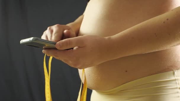 Overweight Fat Woman Beige Underpants Uses Smartphone Mesaurement Tape Hand — Stock Video