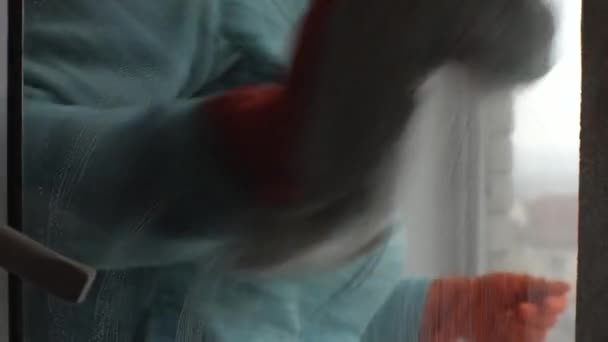 Μια Γυναίκα Πορτοκαλί Γάντια Πλένει Γυαλί Ένα Πλαστικό Παράθυρο Ένα — Αρχείο Βίντεο
