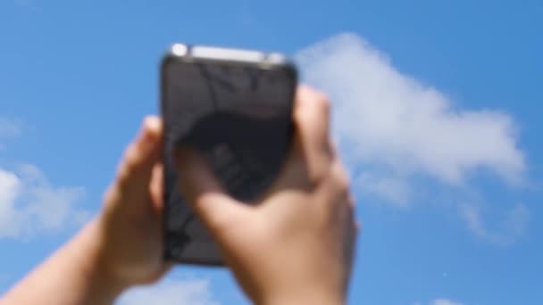Blue Sky Woman Hand Holding Phone Taps Screen His Finger — Stock Video