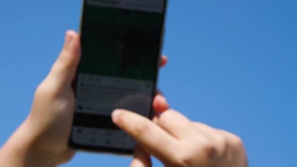 Video Out Focus Women Hands Hold Smartphone Blue Sky Swipe — Vídeos de Stock