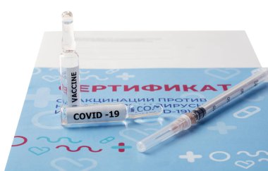 Aşıyla birlikte şırınga ve iki ampul aşı belgesinde var. Çeviri: yeni bir koronavirüs enfeksiyonuna karşı aşı sertifikası COVID-19