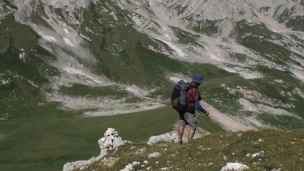 Człowiek Plecakiem Plecach Idzie Dół Trawiastego Zbocza Góry Koncepcja Górskich — Wideo stockowe