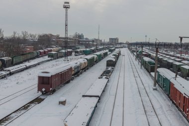 Kışın tren istasyonu. Yük vagonları ve platformlar karla kaplı. Demiryolu taşımacılığı kavramı. Krasnodar, Rusya, 18 Şubat 2021