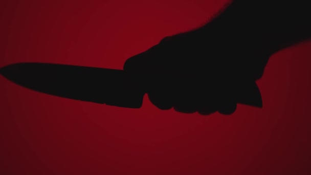 Close Silhouette Man Hand Large Knife Red Background Concept Homicidal — Stock Video