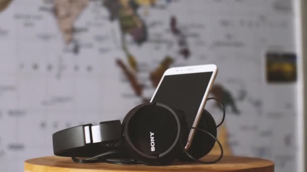 Close Big Black Sony Headphones Xiaomi Smartphone Blurry Map World — Stock Video