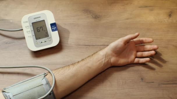 Man Hand Blood Pressure Measuring Device Lies Wooden Table Device — Stock Video