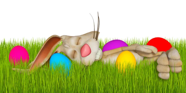 Cartoon Easter bunny sleeping in grass between Easter eggs — Stock Photo, Image