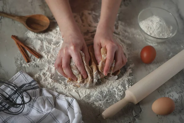 Hands knead the dough. Cookies. Rolling pin flour dough eggs and towel.