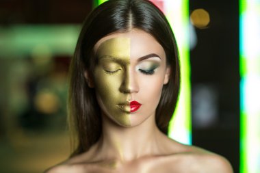 Woman with golden part of face