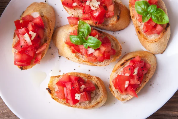 Bruschetta con tomate, cebolla y albahaca — Foto de Stock